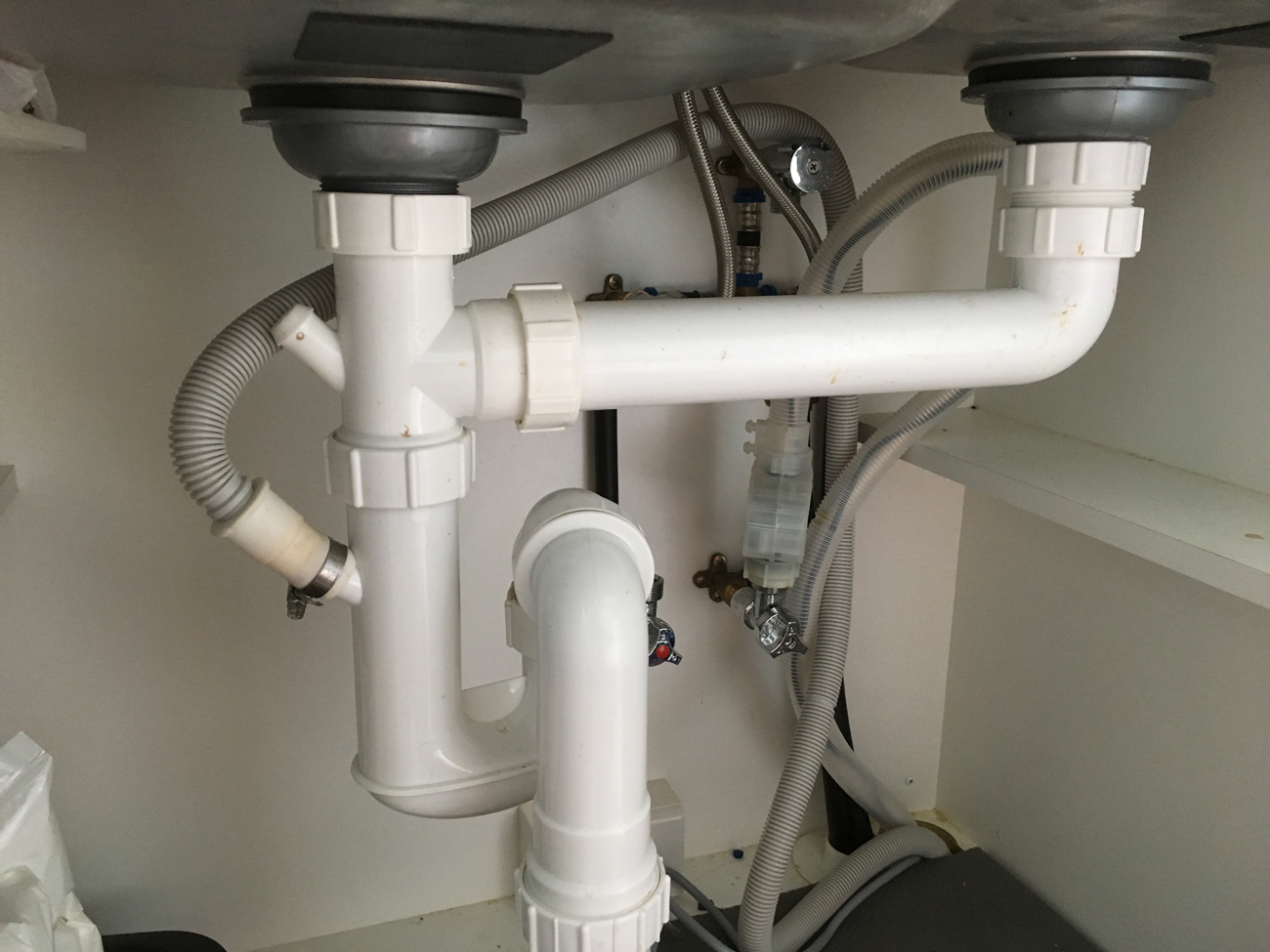 fix plumbing under kitchen sink